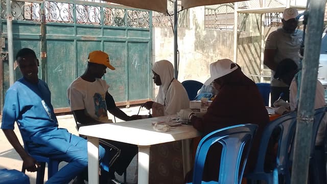 Blood pressure check being administered under tent