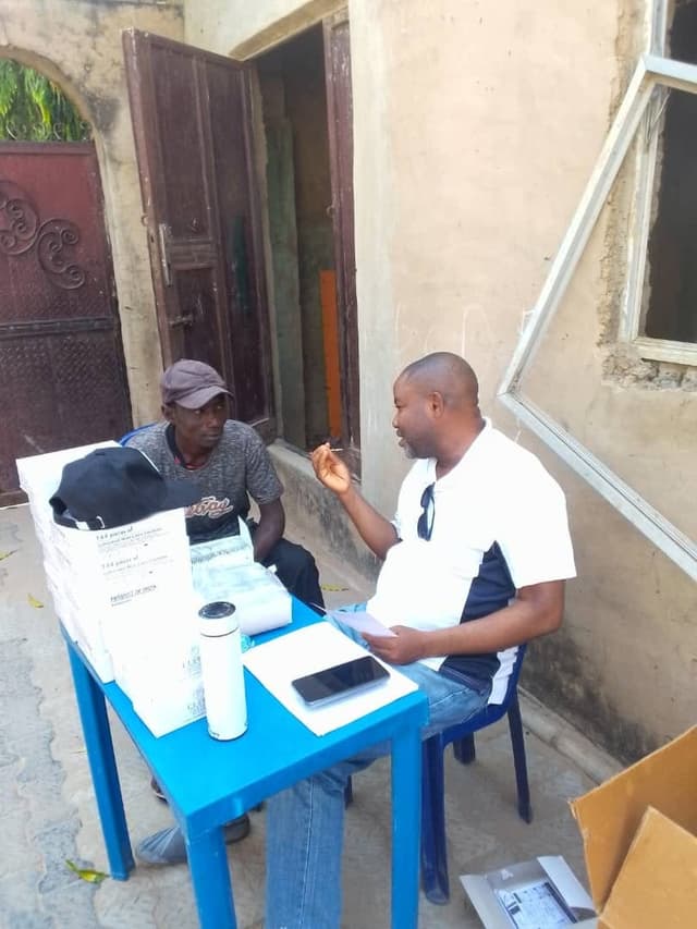 Health worker counseling a community member at a table