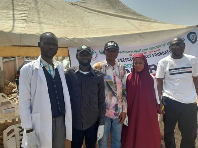 Team group photo under outreach tent